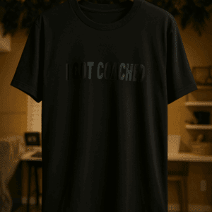 Black T-shirt hanging on a hanger.