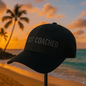 Black cap on tropical beach at sunset.