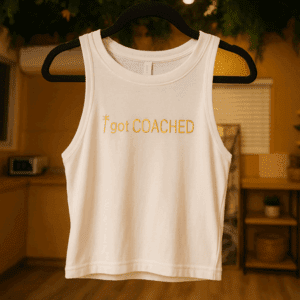 White tank top with "I got COACHED" text.